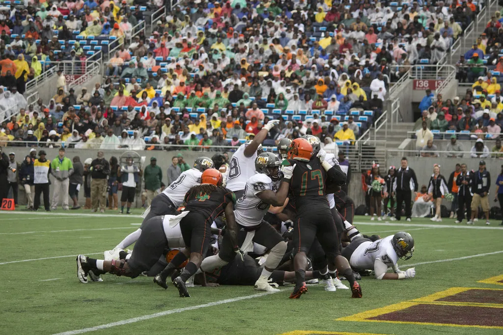 American football on a kicking tee on grass