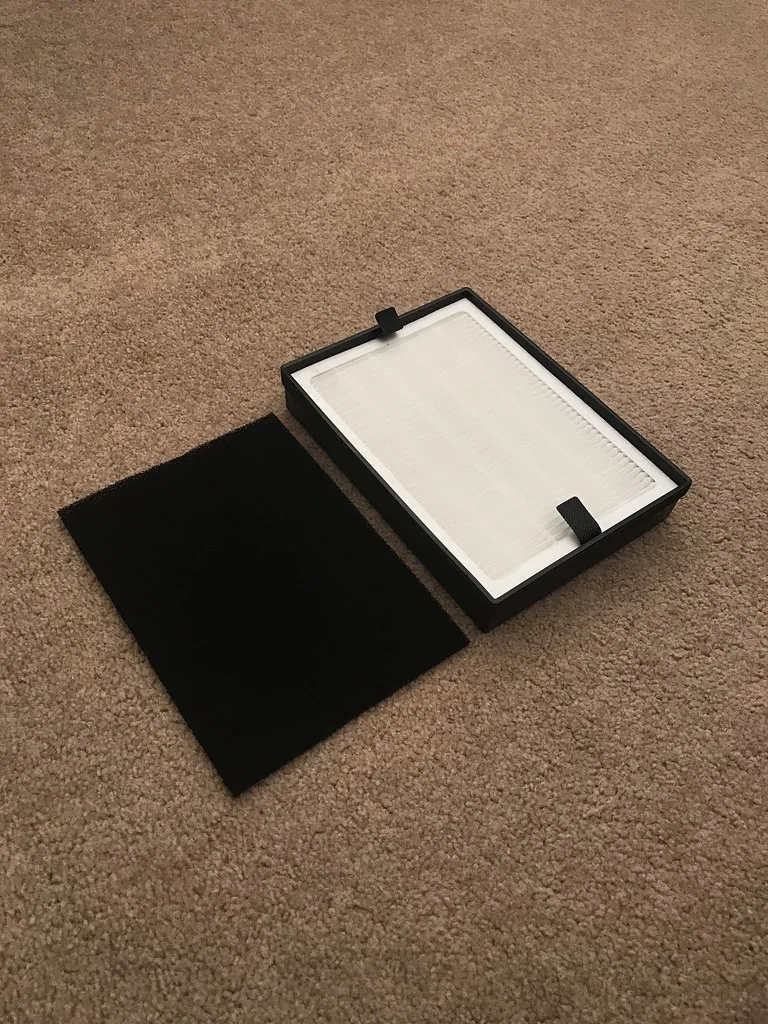 A pleated HEPA air filter held up to the light