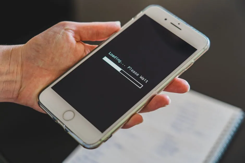 hand holding smartphone with a loading screen displayed