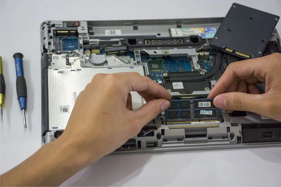 Technician assembling laptop parts