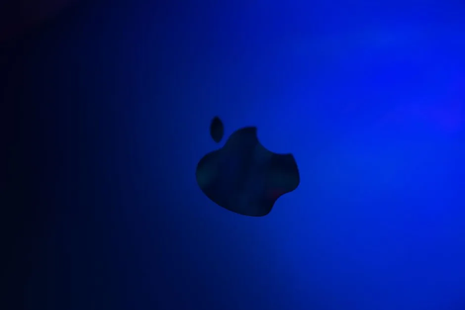 silhouette of an apple logo against blue gradient