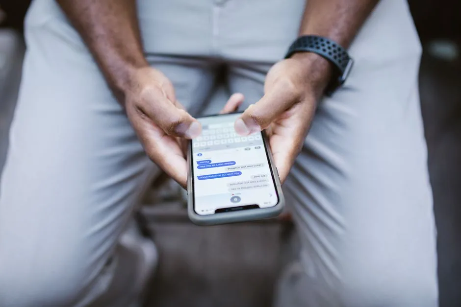 close-up of a man texting on a smartphone