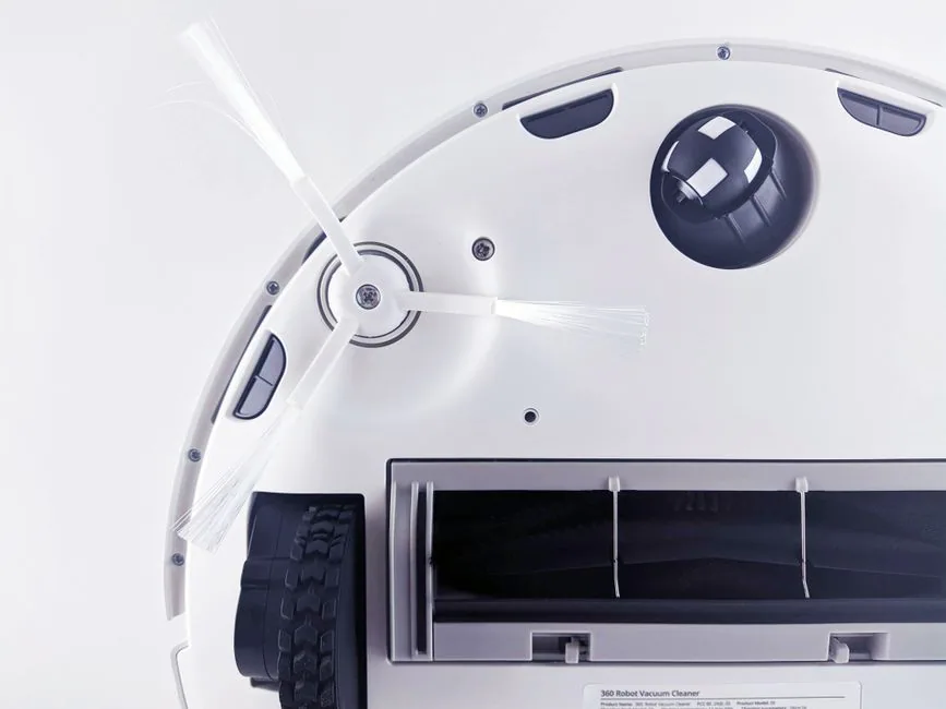 close-up of robotic vacuum underside showing brushes