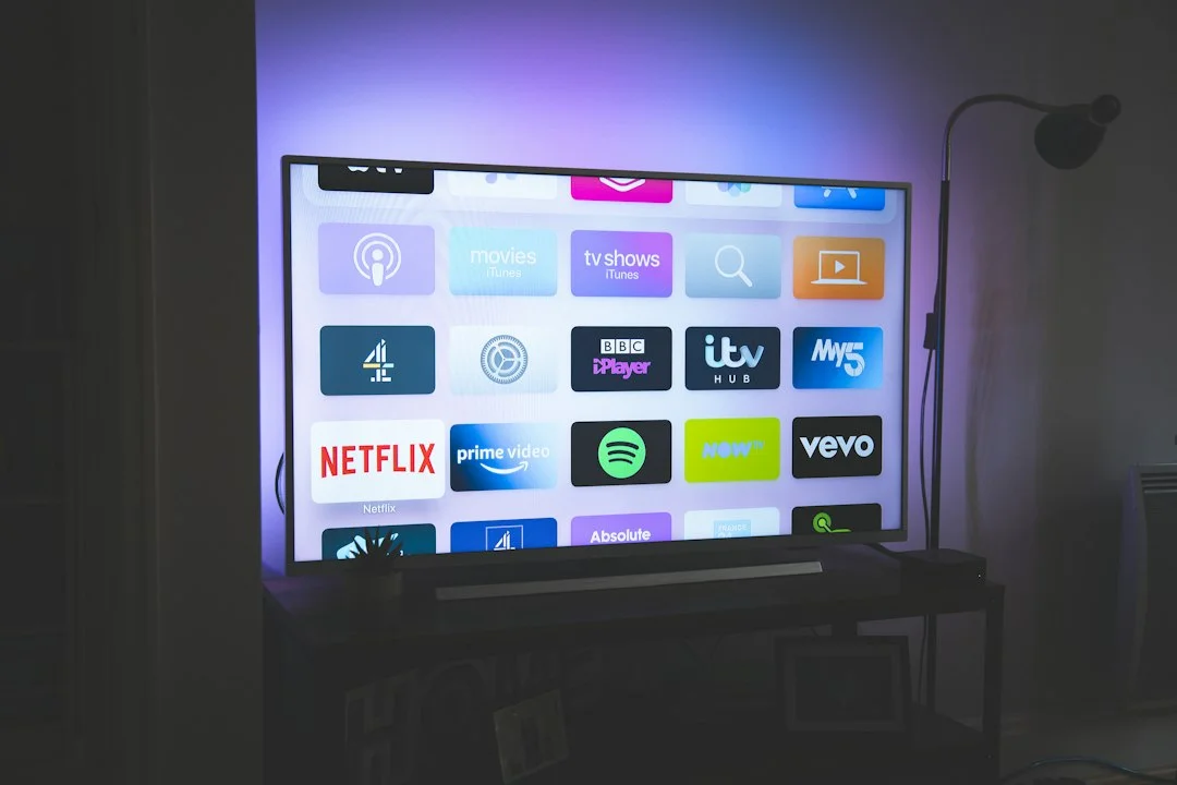 A typical usage scene showing a TV screen displaying the Apple TV home interface with streaming app icons such as Netflix and Prime Video. The screen in the photo is not the Siri AI interface, and it is a neutral reference photo that does not depict search or question-answering features.